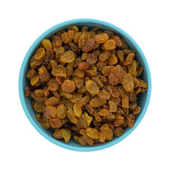 Top view of a blue bowl filled with golden raisins isolated on a white background.