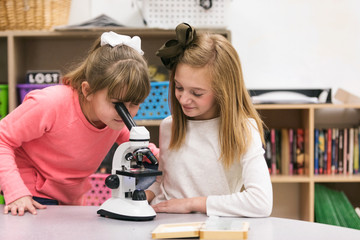 Classroom girls use microscope to examine blood