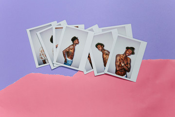 Fuji instant prints of a cool fashionable tattooed man without shirt over ripped pink and purple paper