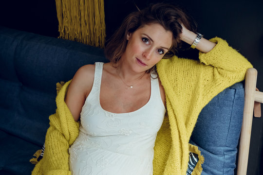 Pregnant woman sitting on a sofa