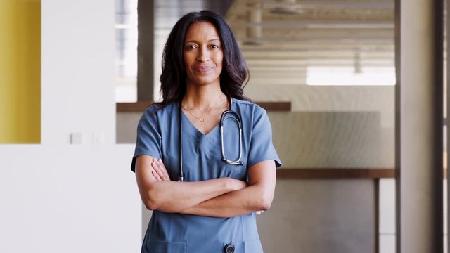 Middle aged female doctor wearing scrubs