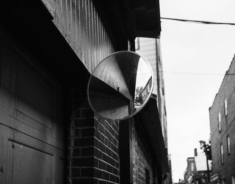 Abstract View Of A Traffic Mirror In A Tight Alleyway