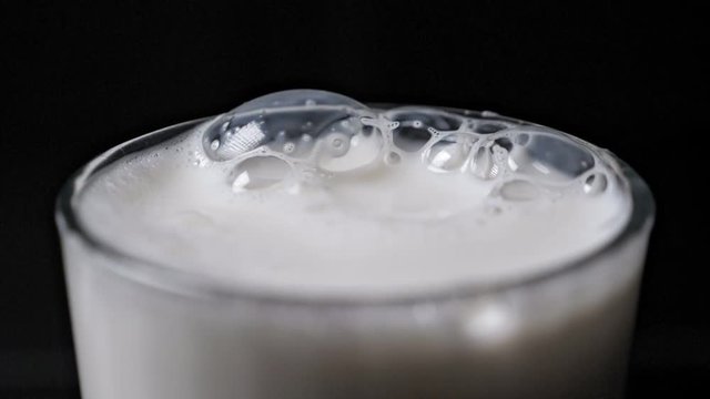 Bubbles in milk in the glass