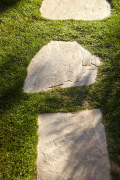 Landscaping with stone pathway in grass at luxury resort