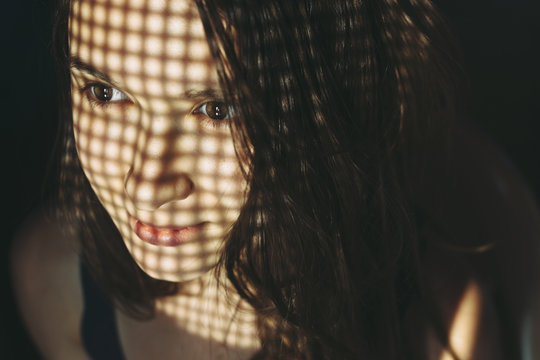 Woman with shadows on face