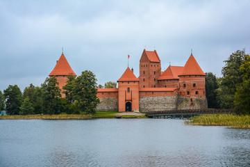 Naklejka na ściany i meble Ancient castle on island in middle of lake. Trakai Island Castle historical landmark, Lithuania.
