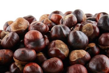 Many peeled chestnuts lie on white background. Isolated