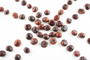 Many peeled chestnuts lie on white background