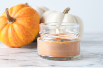 candle with pumpkin and baking ingredients