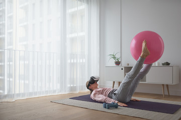 Woman improving her pilates training with vr gear
