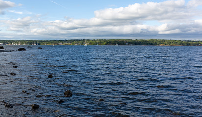 Distant view of the boats in Belfast Harbor in Maine on a cloudy summer day.