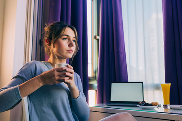 Young woman drinking coffee at home