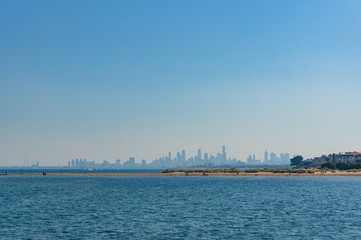 Blue ocean with cityscape with skyscrapers on the background