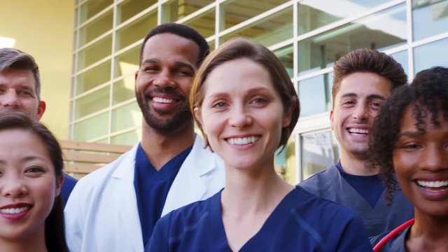 Medical team smiling to camera, close up panning shot