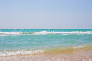 Fototapeta na wymiar azure seashore with waves