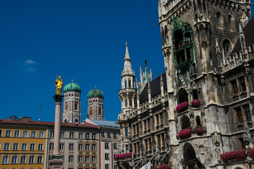 Fototapeta na wymiar Mary's Column (Mariensaule), Frauenkirche (Munich cathedral) and New Town Hall (Neues Rathaus). Mary's Square (Marienplatz). Munich, Germany