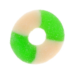 Top view of a single green and white apple flavored candy ring isolated on a white background.