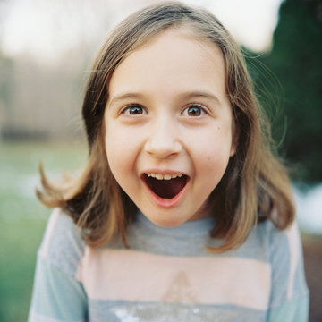 Close up portrait of a young girl looking surprised