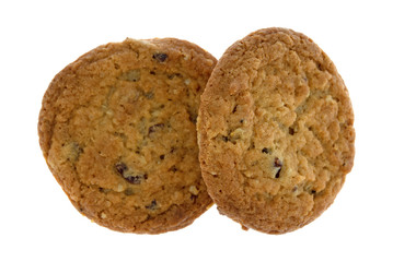Top view of two cranberry and oat cookies isolated on a white background.