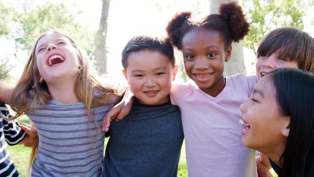 Portrait Of Group Of Children With Friends In Park Shot In Slow Motion