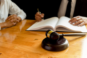 Judge gavel with Justice lawyers having team meeting at law firm background. Concepts of Law and...