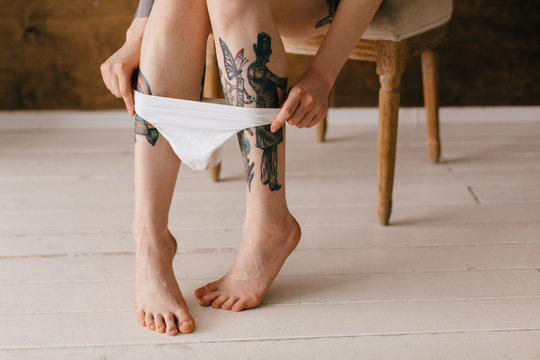 young woman takes off her panties