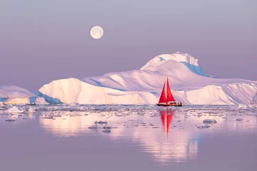 Foto auf Acrylglas Little red sailboat cruising among floating icebergs in Disko Bay glacier during midnight sun season of polar summer. Ilulissat, Greenland. © Kertu