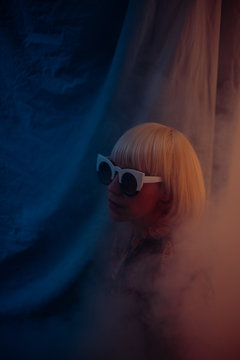 blonde woman with cool sunglasses in a dreamy atmosphere
