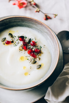 Cauliflower soup with fresh herbs and pomegranate seeds