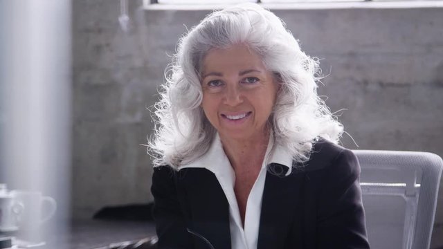 Senior white businesswoman smiling to camera