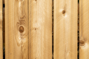 Close up weathered wood background surface. New wooden wall texture planks with knots.