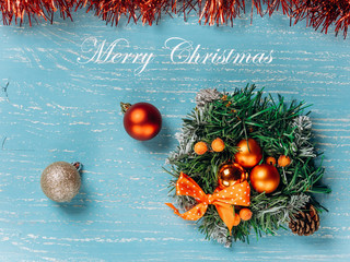 Christmas wreath on blue background and inscription Merry Christmas