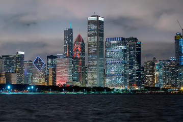 Chicago skyline skyscrapers at night with Lake Michigan in the foreground