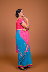 Full length profile view of Indian woman thinking