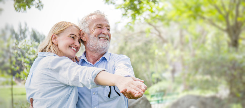 Happy Old Couple Smiling Dancing In A Park On A Sunny Day, Hoot Senior Couple Relax In The Forest Spring Summer Time. Healthcare Lifestyle Retirement Concept Banner