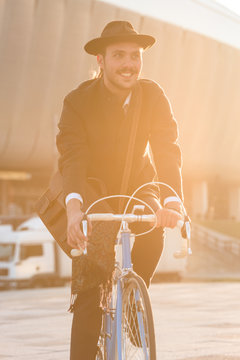 Man riding vintage city bike in the golden hour