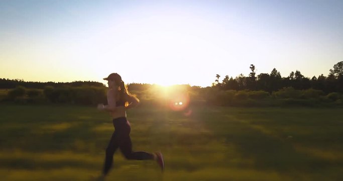 Fit Healthy Young Woman Jogging at Sunrise
