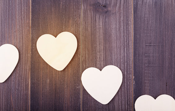 Beautiful paper hearts on wood background