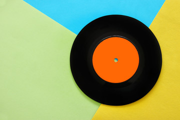 Retro record over pastel yellow and blue double color background. top view. copy space. Flat lay.