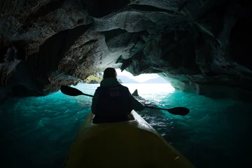 Foto op Canvas Woman paddles kayak inside the marble cave located on the General Carrera lake in Chile © Dudarev Mikhail