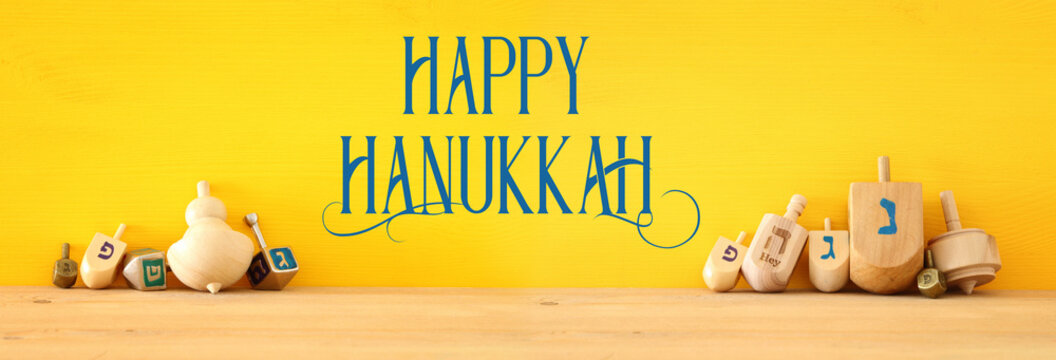 Banner of jewish holiday Hanukkah with wooden dreidels (spinning top).