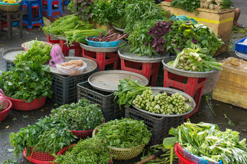 Fresh herbs and greens on sale on fresh produce market