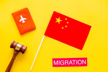 Immigration to China concept. Text innigration near passport cover and chinese flag, judge hammer...