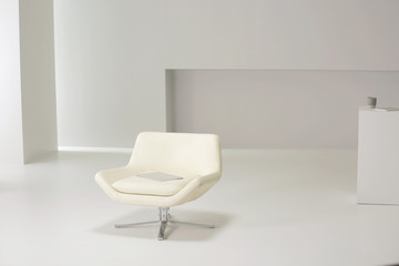 white armchair in white room