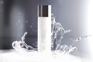 a white cosmetic bottle with water splash