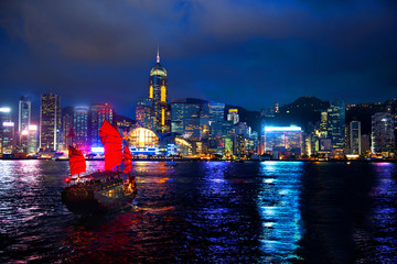 Victoria Harbour Hong Kong night view with junk ship on foreground