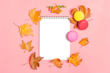 Dry maple leaves, macaroons and white notepad on yellow background Autumn concept To do list Mock up Top view Flat lay Copy space Hello September, October, November