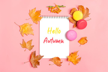 Dry maple leaves, macaroons and white notepad on yellow background Autumn concept To do list Mock up Top view Flat lay Copy space Hello September, October, November