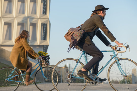 Couple wandering on the city streets with vintage bicycles