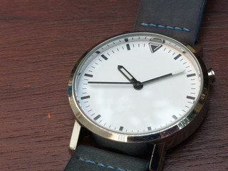 a white watch on the brown background